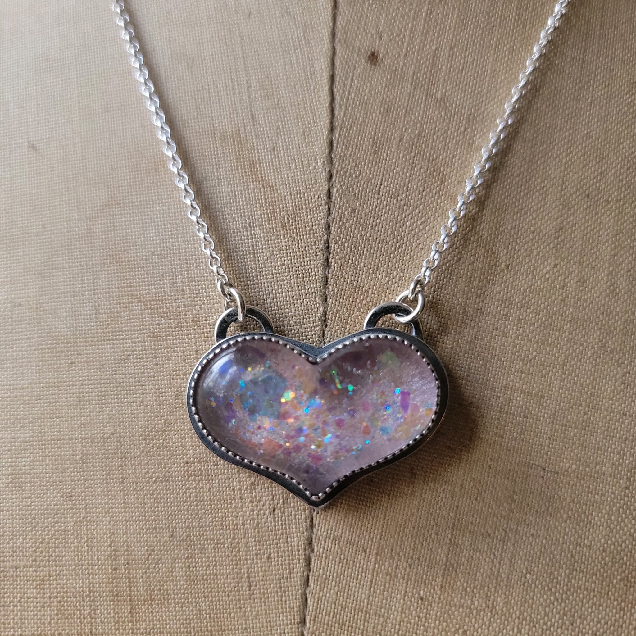 Our Iridescent Heart Necklace ˚ʚ♡ɞ˚ link in bio :) ‎ #handcrafted  #handcraftedjewelry #jewelry #iridescentjewelery #statementn... | Instagram